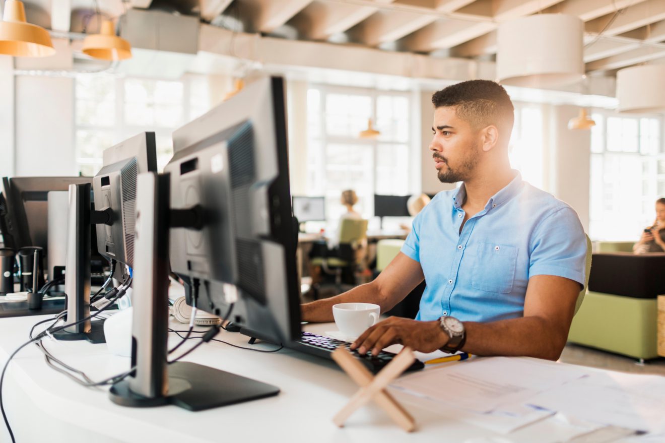Developer on computer in bright office