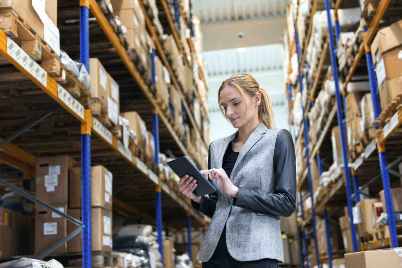 Woman checking tablet on manufacturing floor