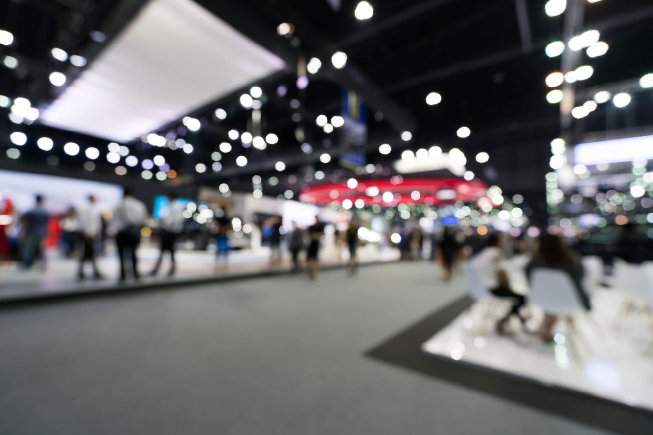 An out-of-focus, wide view of an open convention showcase floor.
