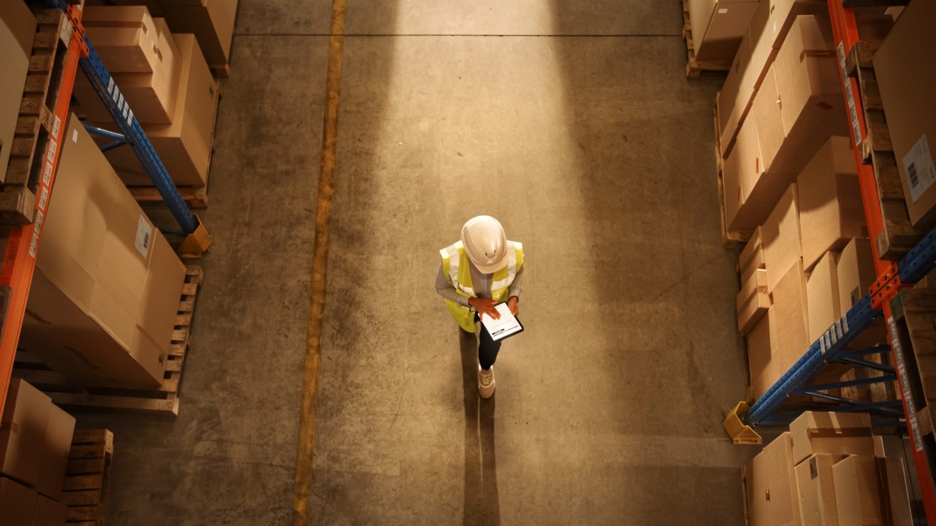 A bird's eye view of a person walking though a warehouse