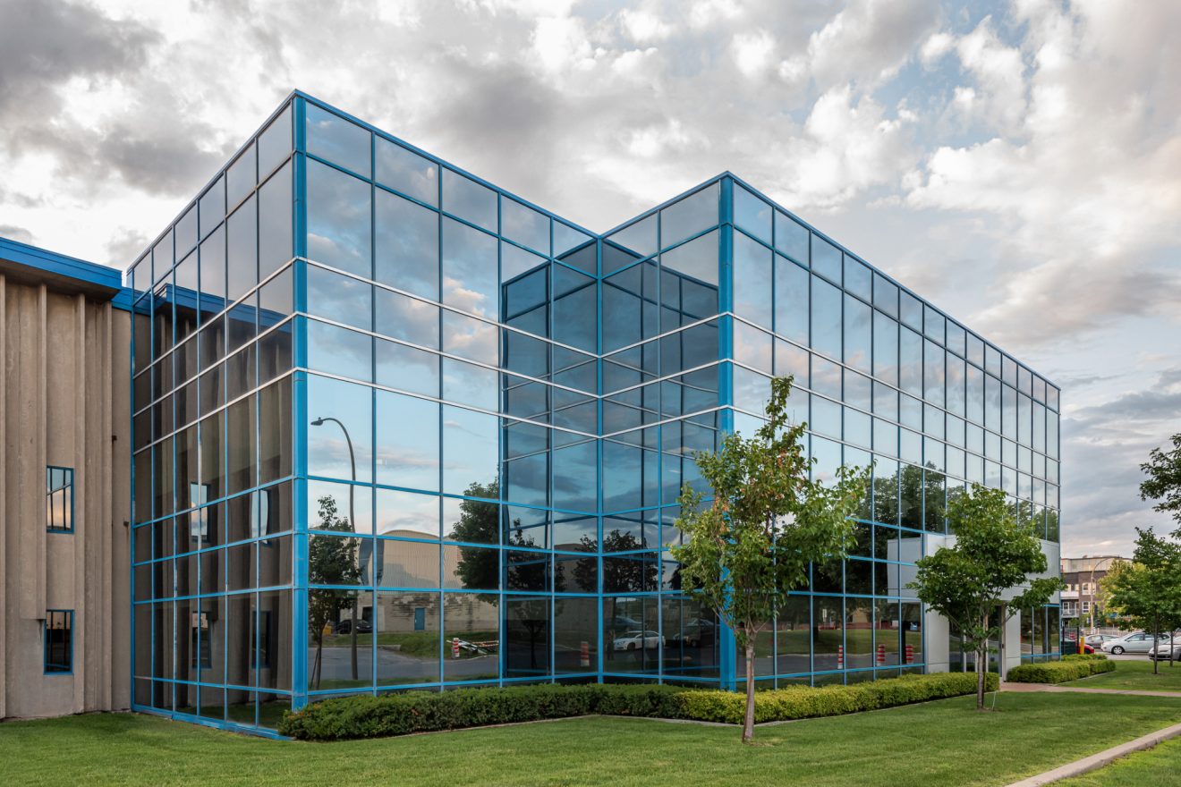 The exterior of a glass-paneled office building