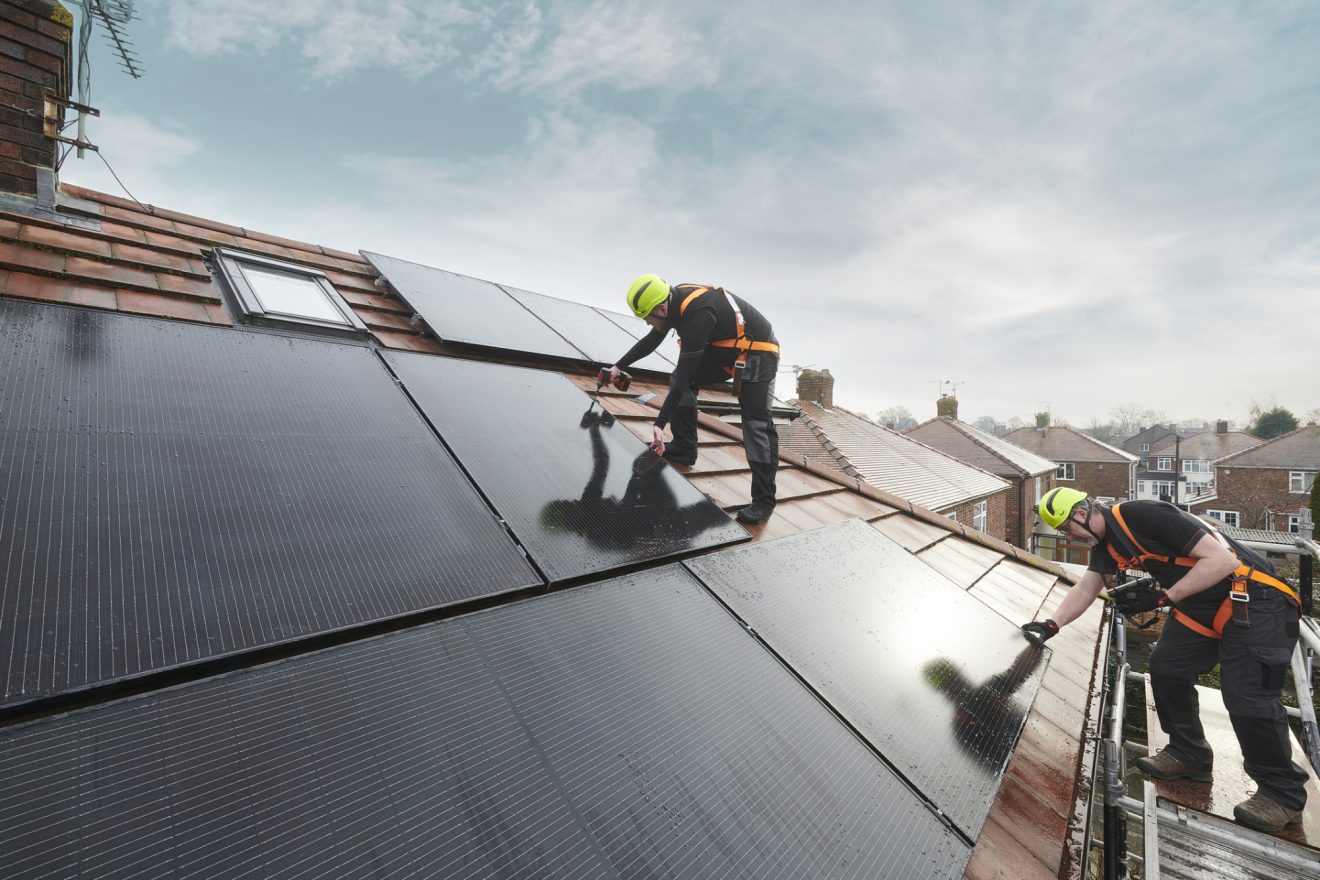 Two people deliver and install solar panels