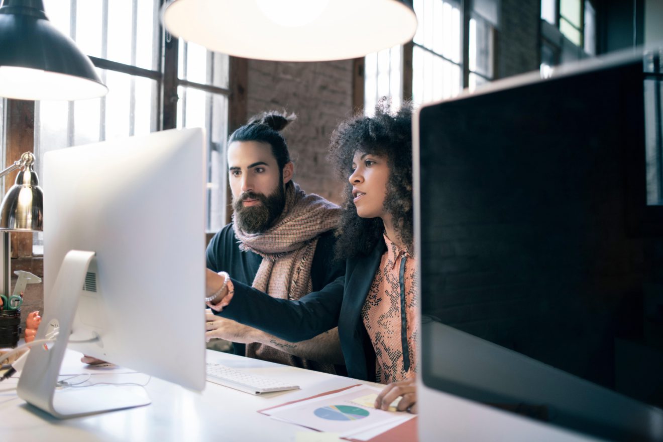 Two developers on computer discussing